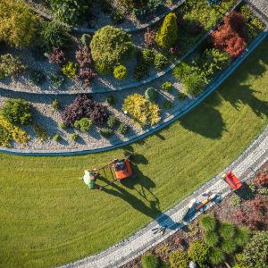Aerial View of Professional Garden Worker with Push Spreader